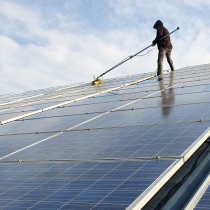 Mann reinigt Solaranlage